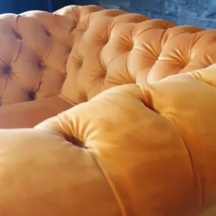Deep-buttoned orange velvet Chesterfield detail