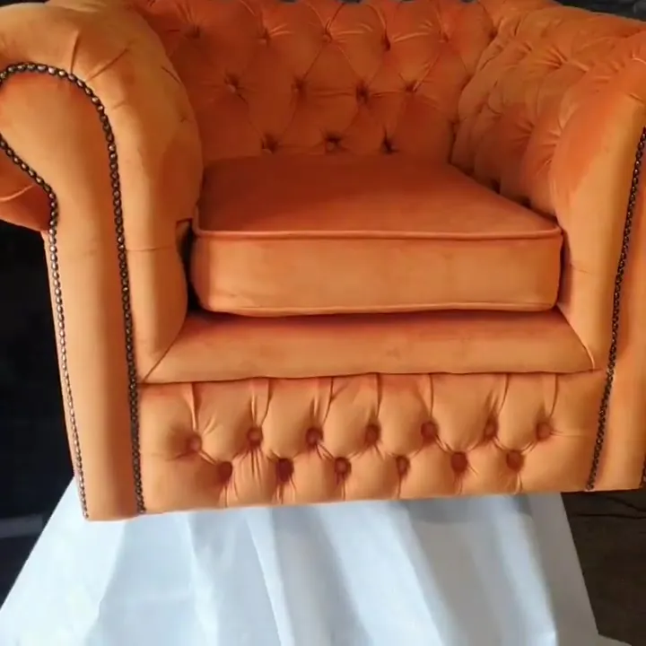 Chesterfield armchair restored and re-covered in burnt orange velvet with deep buttoning and brass studs