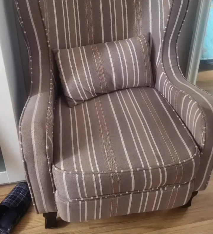 Wingback chair re-covered in a brown and cream stripe